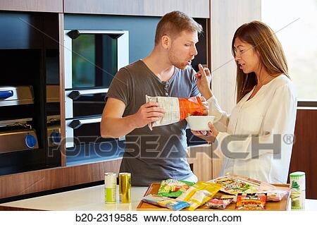 Stock Photography - Family in the kitchen. Couple. Packaged foods.. Fotosearch