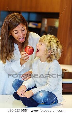 Family in the kitchen. Mother and son. Healthy eating. Healthy growth. Apple. View Large Photo Image Stock Image - Family in the kitchen. Mother and son. Healthy eating. Healthy growth. Apple.. Fotosearch