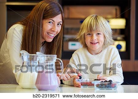 Family in the kitchen. Mother and son. Healthy eating. Healthy growth. Making milkshakes with berries. View Large Photo Image Stock Image - Family in the kitchen. Mother and son. Healthy eating. Healthy growth. Making milkshakes with berries.. Fotosearch