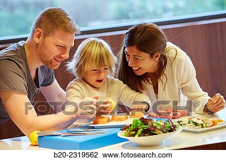 Family in the kitchen. Parents and son. Healthy eating. Healthy growth. Taking lemon fish. View Large Photo Image Stock Image - Family in the kitchen. Parents and son. Healthy eating. Healthy growth. Taking lemon fish.. Fotosearch