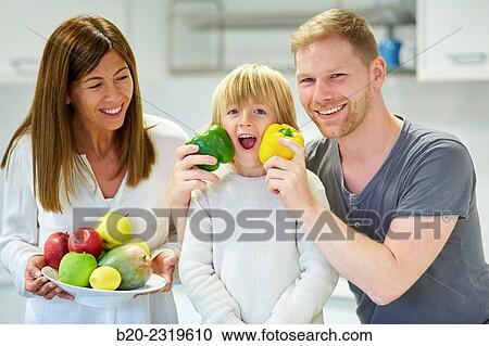 Family in the kitchen. Parents and son. Healthy eating. Healthy growth. Vegetables and fruits. View Large Photo Image Stock Image - Family in the kitchen. Parents and son. Healthy eating. Healthy growth. Vegetables and fruits.. Fotosearch
