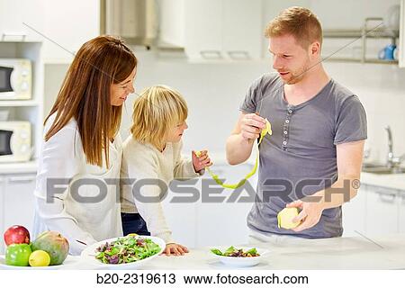 Family in the kitchen. Parents and son. Healthy eating. Healthy growth. Peeling an apple. View Large Photo Image Stock Image - Family in the kitchen. Parents and son. Healthy eating. Healthy growth. Peeling an apple.. Fotosearch
