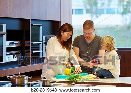 Family in the kitchen. Parents and son. Healthy eating. Healthy growth. Vegetables and fruits. View Large Photo Image Stock Photo - Family in the kitchen. Parents and son. Healthy eating. Healthy growth. Vegetables and fruits.. Fotosearch