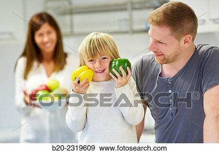 Family in the kitchen. Parents and son. Healthy eating. Healthy growth. Vegetables. View Large Photo Image Stock Photo - Family in the kitchen. Parents and son. Healthy eating. Healthy growth. Vegetables.. Fotosearch
