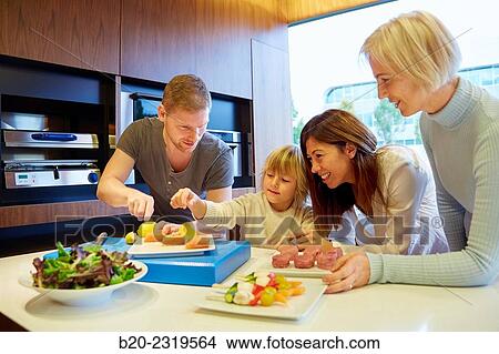 Family in the kitchen. Three generations. Healthy eating. Healthy growth. Vegetables and fish. View Large Photo Image Picture - Family in the kitchen. Three generations. Healthy eating. Healthy growth. Vegetables and fish.. Fotosearch