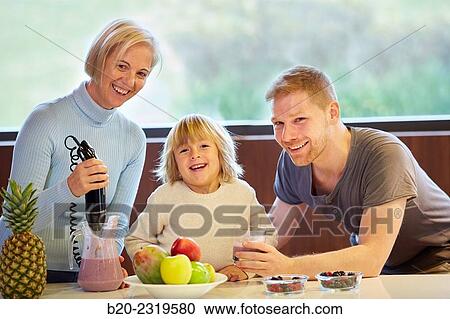 Family in the kitchen. Three generations. Healthy eating. Healthy growth. Making milkshakes with berries. View Large Photo Image Stock Image - Family in the kitchen. Three generations. Healthy eating. Healthy growth. Making milkshakes with berries.. Fotosearch