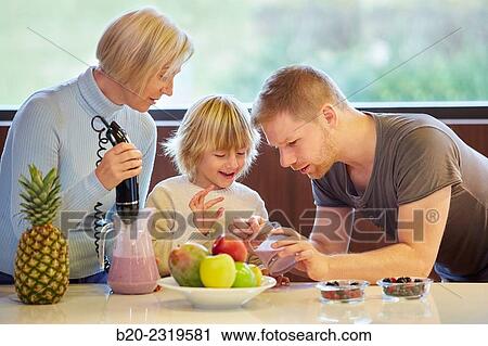 Family in the kitchen. Three generations. Healthy eating. Healthy growth. Making milkshakes with berries. View Large Photo Image Stock Image - Family in the kitchen. Three generations. Healthy eating. Healthy growth. Making milkshakes with berries.. Fotosearch