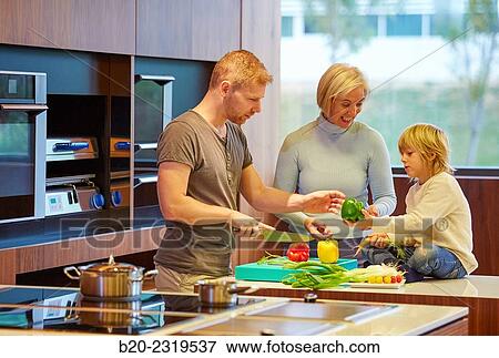 Family in the kitchen. Three generations. Healthy eating. Healthy growth. Vegetables. View Large Photo Image Stock Photo - Family in the kitchen. Three generations. Healthy eating. Healthy growth. Vegetables.. Fotosearch