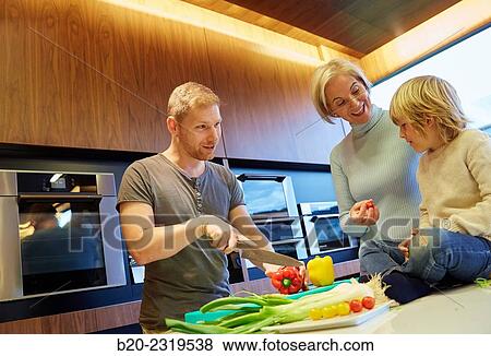 Family in the kitchen. Three generations. Healthy eating. Healthy growth. Vegetables. View Large Photo Image Stock Photo - Family in the kitchen. Three generations. Healthy eating. Healthy growth. Vegetables.. Fotosearch