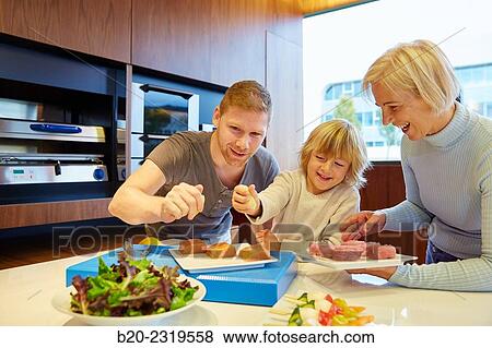 Family in the kitchen. Three generations. Healthy eating. Healthy growth. Taking lemon fish. View Large Photo Image Stock Photo - Family in the kitchen. Three generations. Healthy eating. Healthy growth. Taking lemon fish.. Fotosearch