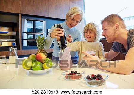 Family in the kitchen. Three generations. Healthy eating. Healthy growth. Making milkshakes with berries. View Large Photo Image Stock Photo - Family in the kitchen. Three generations. Healthy eating. Healthy growth. Making milkshakes with berries.. Fotosearch