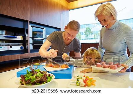 Family in the kitchen. Three generations. Healthy eating. Healthy growth. Taking lemon fish. View Large Photo Image Stock Photograph - Family in the kitchen. Three generations. Healthy eating. Healthy growth. Taking lemon fish.. Fotosearch