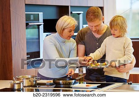 Family in the kitchen. Three generations. Healthy eating. Healthy growth. Cooking fish and vegetable skewer. View Large Photo Image Stock Photograph - Family in the kitchen. Three generations. Healthy eating. Healthy growth. Cooking fish and vegetable skewer.. Fotosearch