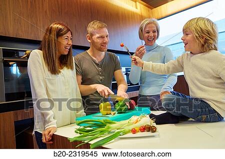 Stock Photography - Family in the kitchen. Three generations. Healthy eating. Healthy growth. Vegetables.. Fotosearch