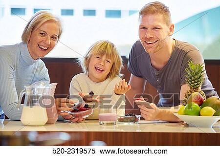 Family in the kitchen. Three generations. Healthy eating. Healthy growth. Making milkshakes with berries. View Large Photo Image Stock Photography - Family in the kitchen. Three generations. Healthy eating. Healthy growth. Making milkshakes with berries.. Fotosearch