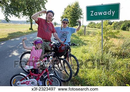 Family of three generations celebrating a successful bicycle trip. Zawady Poland. View Large Photo Image Stock Photo - Family of three generations celebrating a successful bicycle trip. Zawady Poland.. Fotosearch