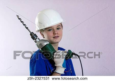 Girl in working clothes with construction tools. View Large Photo Image Stock Image - Girl in working clothes with construction tools.. Fotosearch
