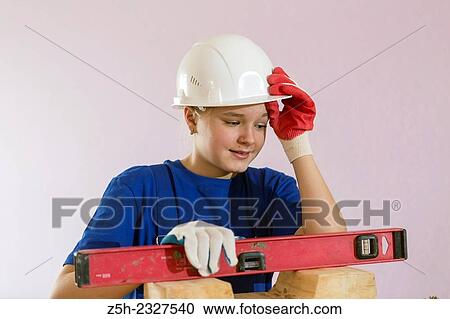 Girl in working clothes with construction tools. View Large Photo Image Stock Image - Girl in working clothes with construction tools.. Fotosearch