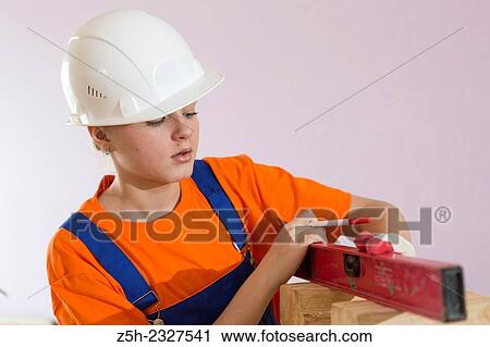 Girl in working clothes with construction tools. View Large Photo Image Stock Image - Girl in working clothes with construction tools.. Fotosearch