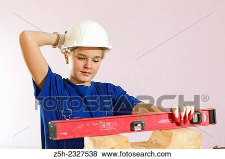 Girl in working clothes with construction tools. View Large Photo Image Stock Photo - Girl in working clothes with construction tools.. Fotosearch