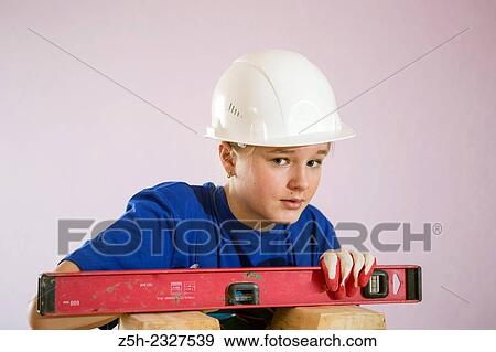 Girl in working clothes with construction tools. View Large Photo Image Stock Photo - Girl in working clothes with construction tools.. Fotosearch