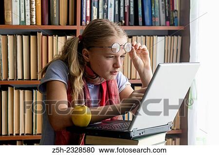 Girl with a computer in the reading room. View Large Photo Image Stock Image - Girl with a computer in the reading room.. Fotosearch