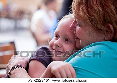 Stock Image - Granddaughter affectionately nuzzling up to grandmother age 6 and 71. Spala Central Poland.. Fotosearch