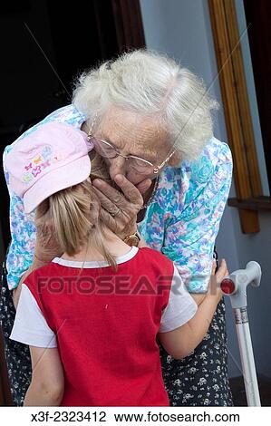 Great grandmother affectionally kissing young girl goodbye age 88 and 5. Zawady Central Poland. View Large Photo Image Stock Image - Great grandmother affectionally kissing young girl goodbye age 88 and 5. Zawady Central Poland.. Fotosearch
