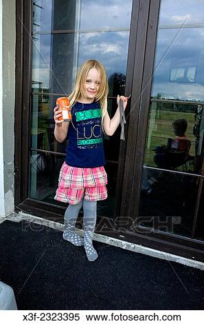 Happy young girl fashionably dressed age 6 holding can of soda at front door. Zawady Central Poland. View Large Photo Image Stock Photography - Happy young girl fashionably dressed age 6 holding can of soda at front door. Zawady Central Poland.. Fotosearch