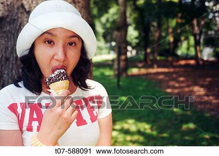 Hispanic woman eating ice-creamm in Central Park, New York City View Large Photo Image Stock Image - Hispanic woman eating ice-creamm in Central Park, New York City. Fotosearch
