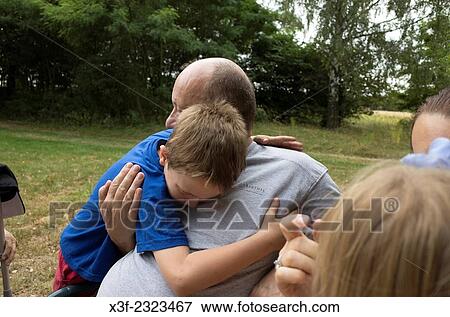 Loving Polish Grandson hugs his grandfather at family picnic. Zawady Central Poland. View Large Photo Image Stock Photo - Loving Polish Grandson hugs his grandfather at family picnic. Zawady Central Poland.. Fotosearch