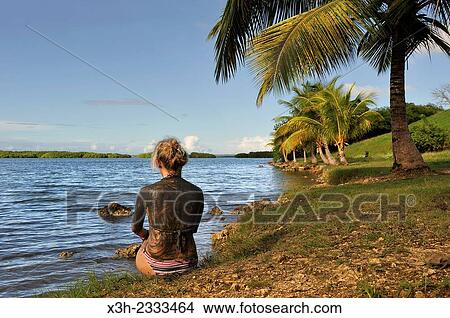Picture - mud bath at Babin beach, Morne-a-l'eau, Grande-Terre, Guadeloupe, overseas region of France, Leewards Islands, Lesser Antilles, Caribbean.. Fotosearch