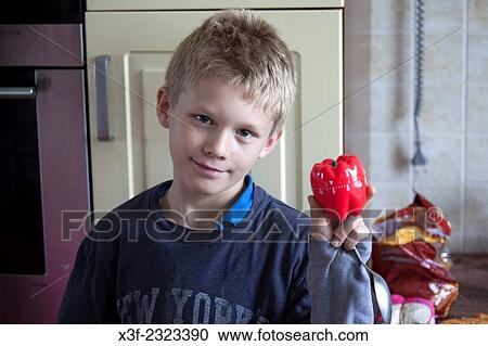 Polish boy age 10 showing his new timer in the shape of a plastic red pepper. Zawady Central Poland. View Large Photo Image Stock Image - Polish boy age 10 showing his new timer in the shape of a plastic red pepper. Zawady Central Poland.. Fotosearch
