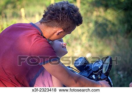 Polish child getting ready for motorcycle ride from neighbor teen boy age 18 and 6. Zawady Central Poland. View Large Photo Image Stock Photo - Polish child getting ready for motorcycle ride from neighbor teen boy age 18 and 6. Zawady Central Poland.. Fotosearch