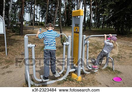 Polish children playing on outside park exercise equipment. Rawa Mazowiecka Poland. View Large Photo Image Picture - Polish children playing on outside park exercise equipment. Rawa Mazowiecka Poland.. Fotosearch