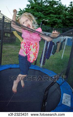 Polish girl age 6 jumping on her trampoline. Zawady Central Poland. View Large Photo Image Stock Image - Polish girl age 6 jumping on her trampoline. Zawady Central Poland.. Fotosearch