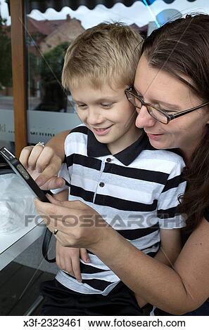 Polish mom and son age 10 and 34 playing on her cell phone. Rawa Mazowiecka Central Poland. View Large Photo Image Stock Image - Polish mom and son age 10 and 34 playing on her cell phone. Rawa Mazowiecka Central Poland.. Fotosearch