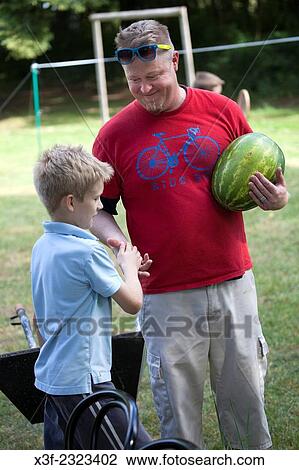 Polish son congratulating his father on picking out such a nice watermelon. Zawady Central Poland. View Large Photo Image Stock Image - Polish son congratulating his father on picking out such a nice watermelon. Zawady Central Poland.. Fotosearch