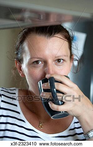 Stock Image - Polish woman age 34 enjoying a soothing cup of coffee. Zawady Central Poland.. Fotosearch