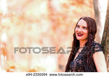 Portrait of a 33 year old brunette woman outdoors. View Large Photo Image Picture - Portrait of a 33 year old brunette woman outdoors.. Fotosearch