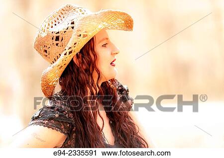 Portrait of a 33 year old brunette woman wearing a straw hat and looking away from the camera, outdoors. View Large Photo Image Stock Image - Portrait of a 33 year old brunette woman wearing a straw hat and looking away from the camera, outdoors.. Fotosearch