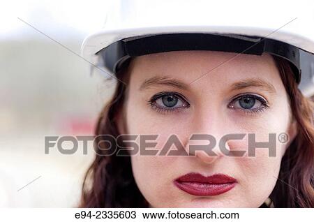 Portrait of a 33 year old brunette woman wearing a hard hat looking directly at the camera. View Large Photo Image Stock Image - Portrait of a 33 year old brunette woman wearing a hard hat looking directly at the camera.. Fotosearch