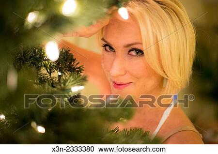 Pretty blonde woman by christmas tree. View Large Photo Image Stock Image - Pretty blonde woman by christmas tree.. Fotosearch