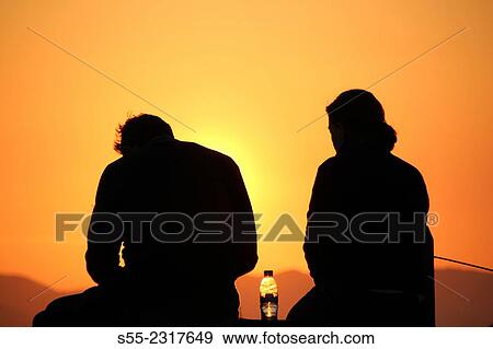 Quarrel. A man and a woman watching the sunset in Collserola mountain, Barcelona, Catalonia, Spain. View Large Photo Image Stock Photo - Quarrel. A man and a woman watching the sunset in Collserola mountain, Barcelona, Catalonia, Spain.. Fotosearch