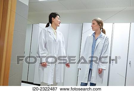 Stock Photo - Researchers in the dressing room. White coats. Technological Services to Industry. Tecnalia Research & Innovation, Donostia, San Sebastian, Gipuzkoa, Basque Country, Spain.. Fotosearch