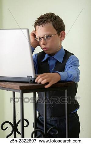 Schoolboy is studying laptop. View Large Photo Image Stock Photo - Schoolboy is studying laptop.. Fotosearch