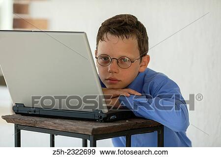 Schoolboy is studying laptop. View Large Photo Image Stock Photo - Schoolboy is studying laptop.. Fotosearch