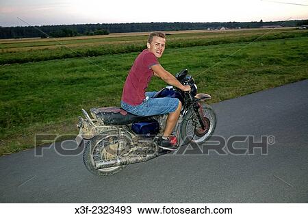 Teen ridding motorcycle. View Large Photo Image Stock Image - Teen ridding motorcycle.. Fotosearch