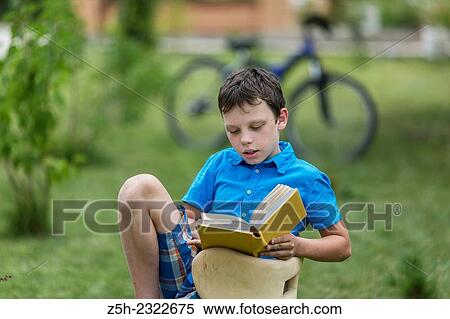 Teen twelve years in the garden with a book. View Large Photo Image Stock Photography - Teen twelve years in the garden with a book.. Fotosearch