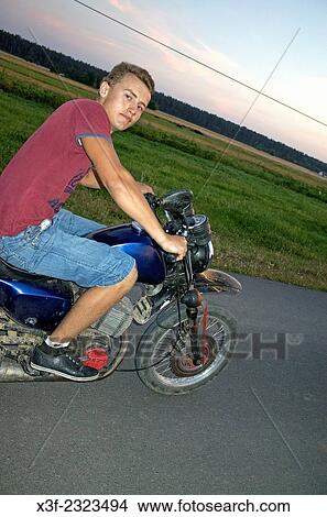 teenager rides his motorcycle. View Large Photo Image Picture - teenager rides his motorcycle.. Fotosearch